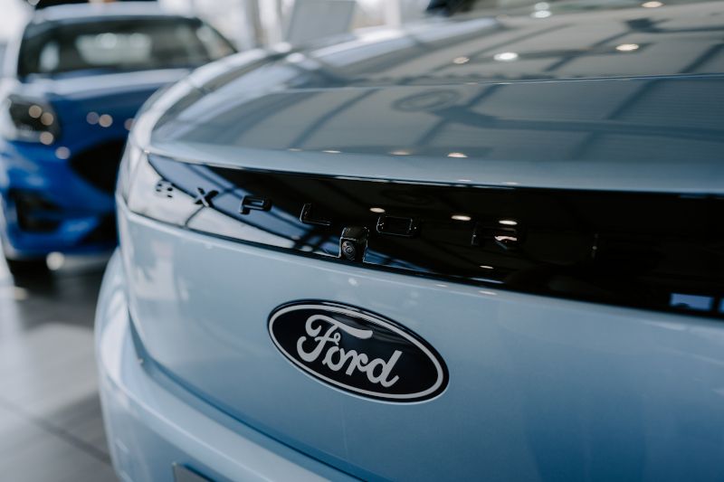 Front of Ford Explorer in arctic blue showing the ford logo