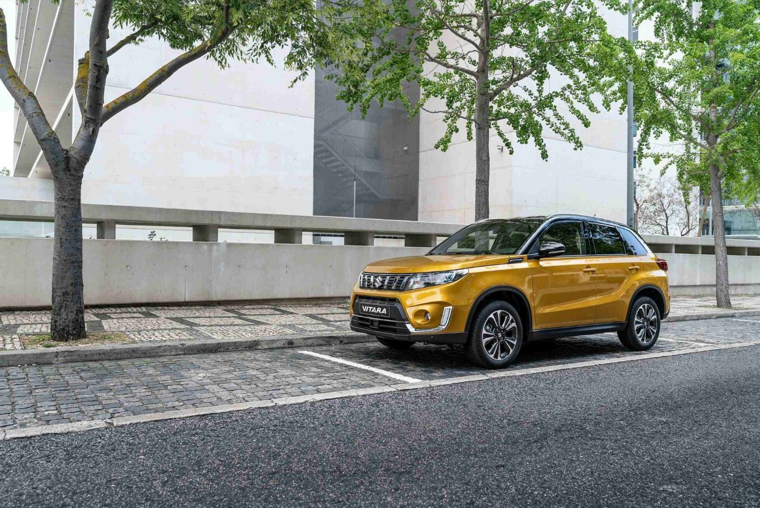Image of Yellow Suzuki Vitara Driving in the City
