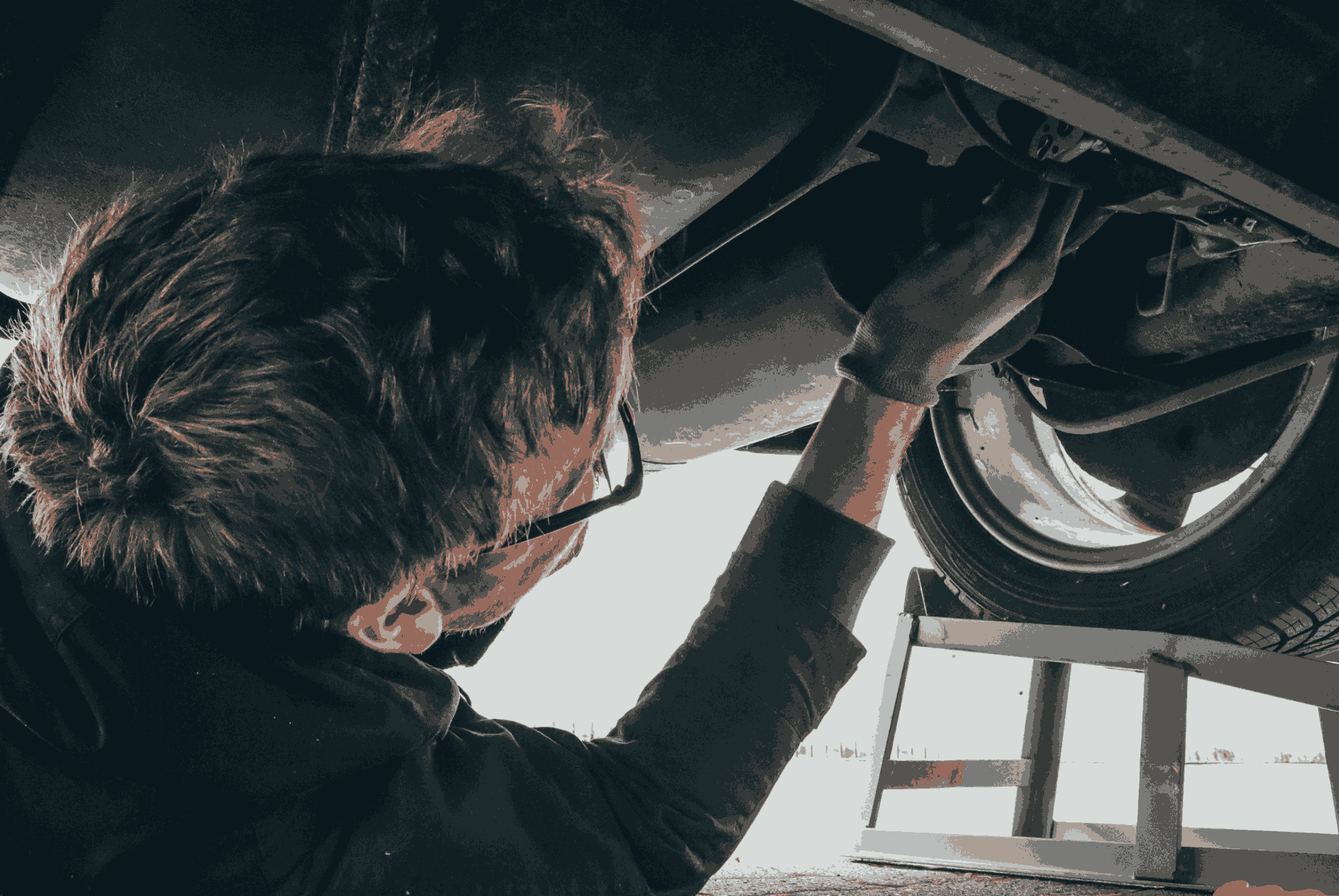 Technician Looking Under a Car