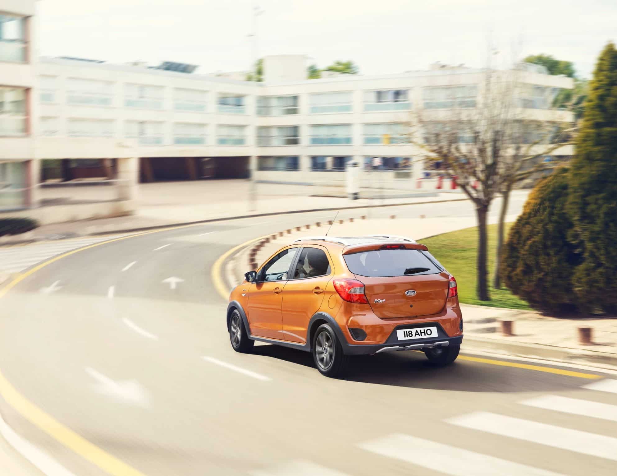 Orange ford KA driving on road
