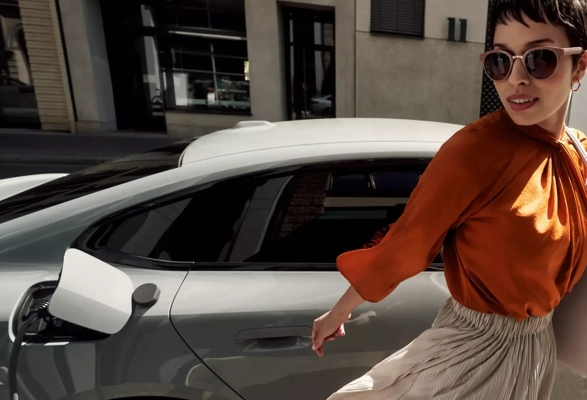 women walking away from electric car