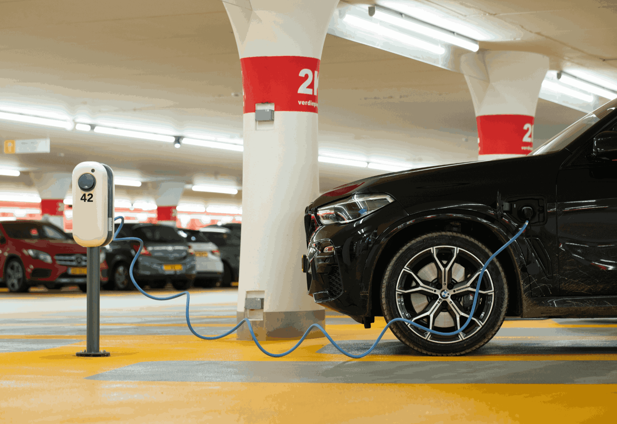 BMW plugged into indoor charging station
