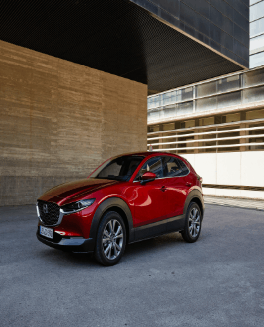 Image of Red Mazda CX 30 Parked Up Next to a Modern Building