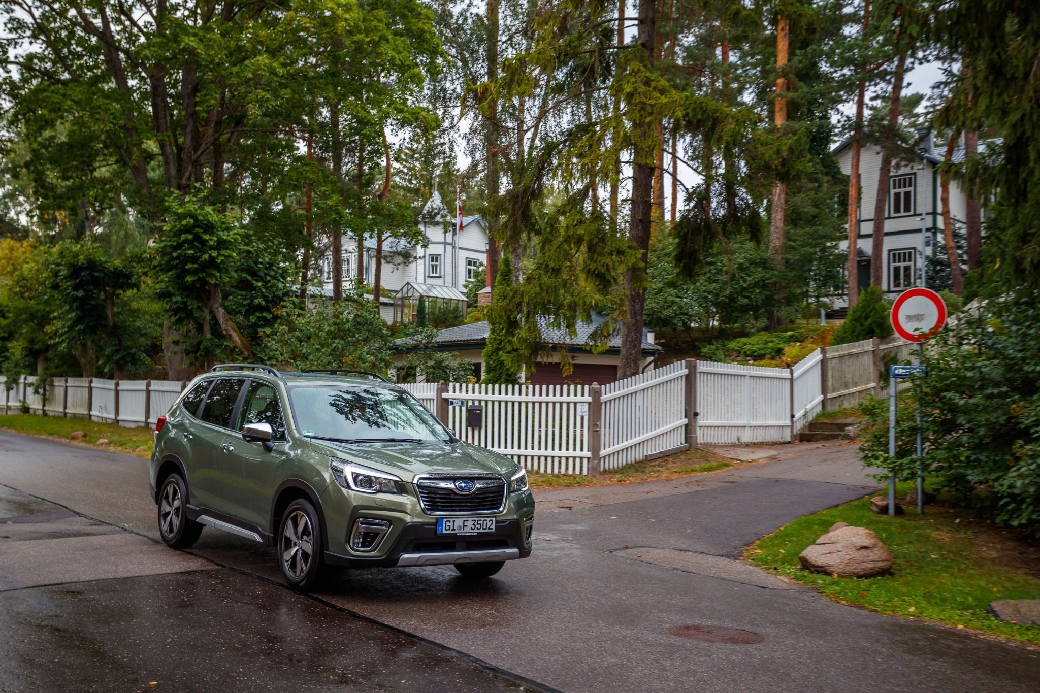 green subaru forester parked outside houses side front view