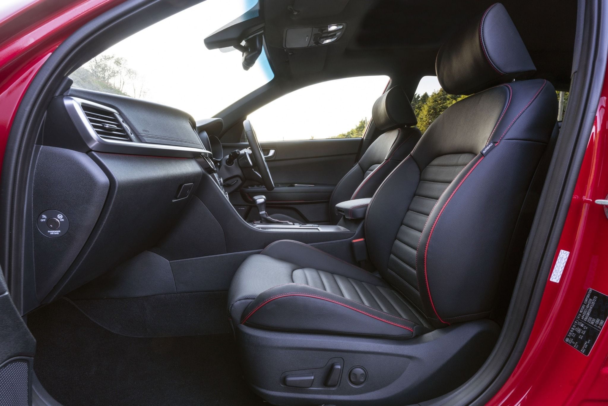 front interior seat of kia optima sportwagon through open door