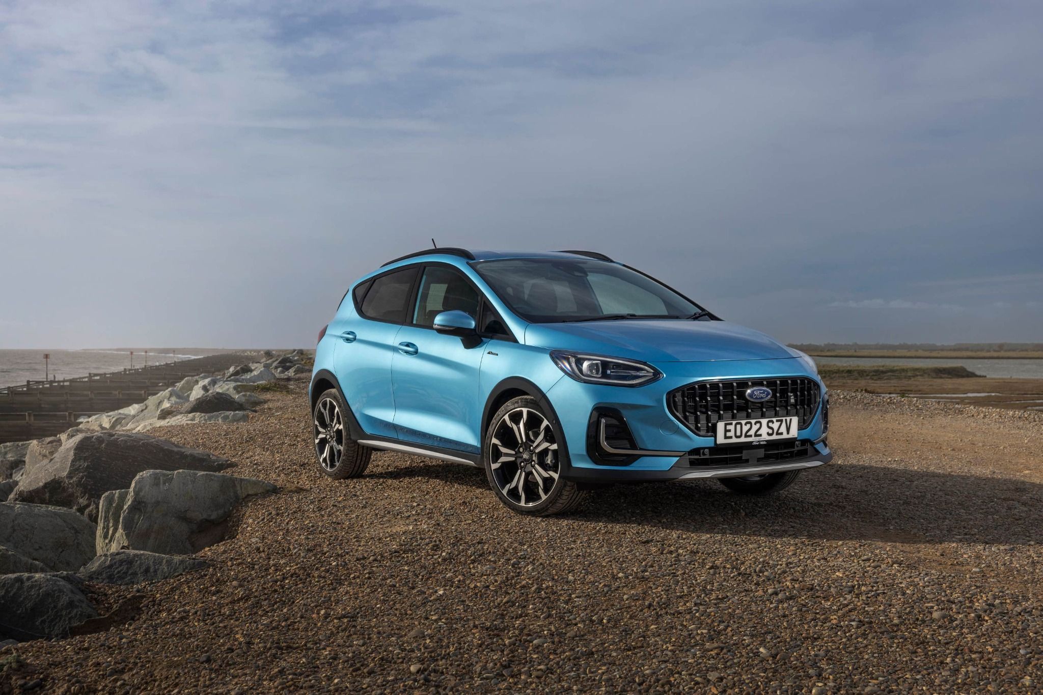 front side view of blue fiesta 9 model in desert