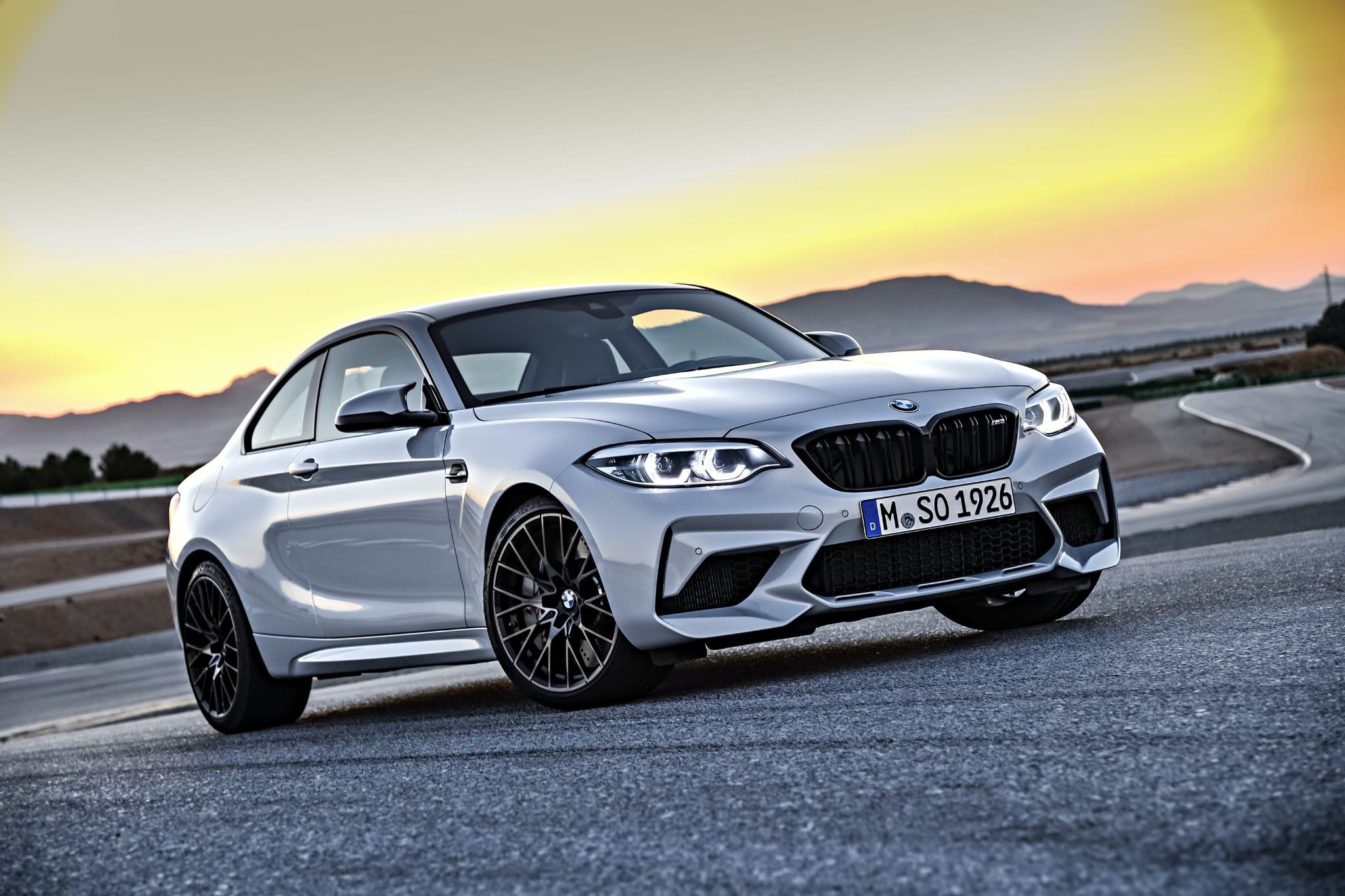 BMW m2 parked with sunset in background