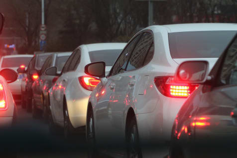 Cars lined up with break lights on