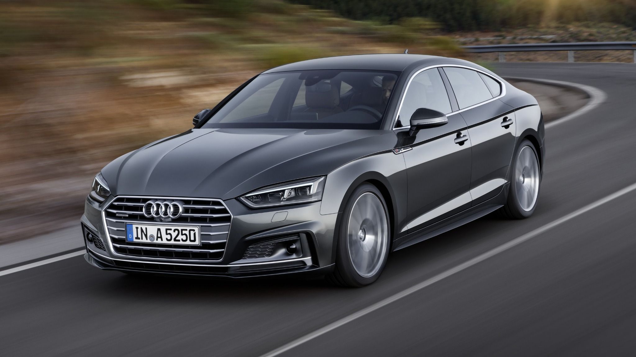 Grey Audi A5 Sportback Driving Fast Along a Main Road