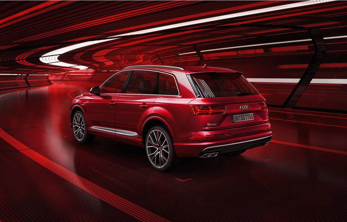 Red Audi SQ7 Driving through an Underground Tunnel