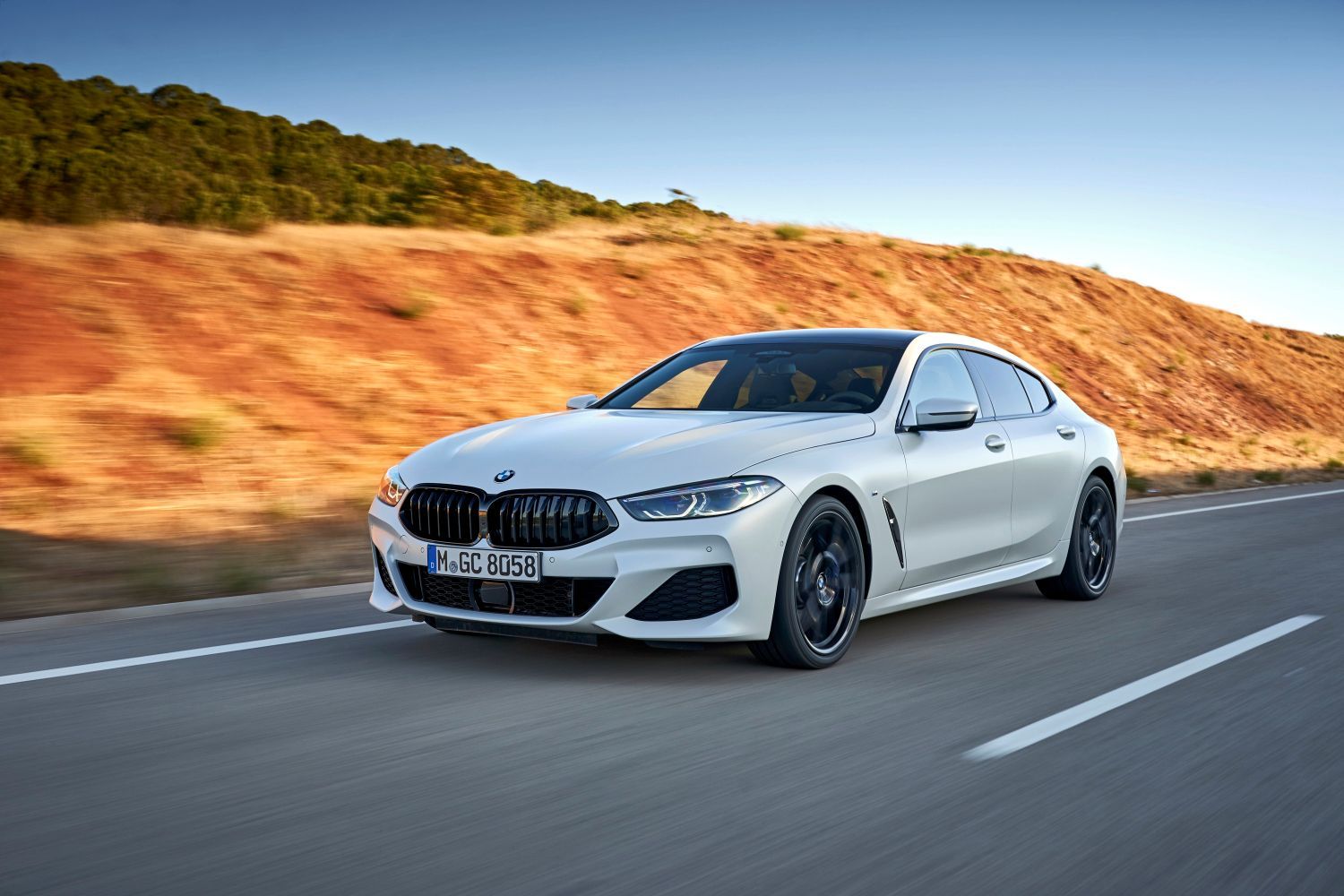 Image of White BMW 8 Series Driving Along the Road