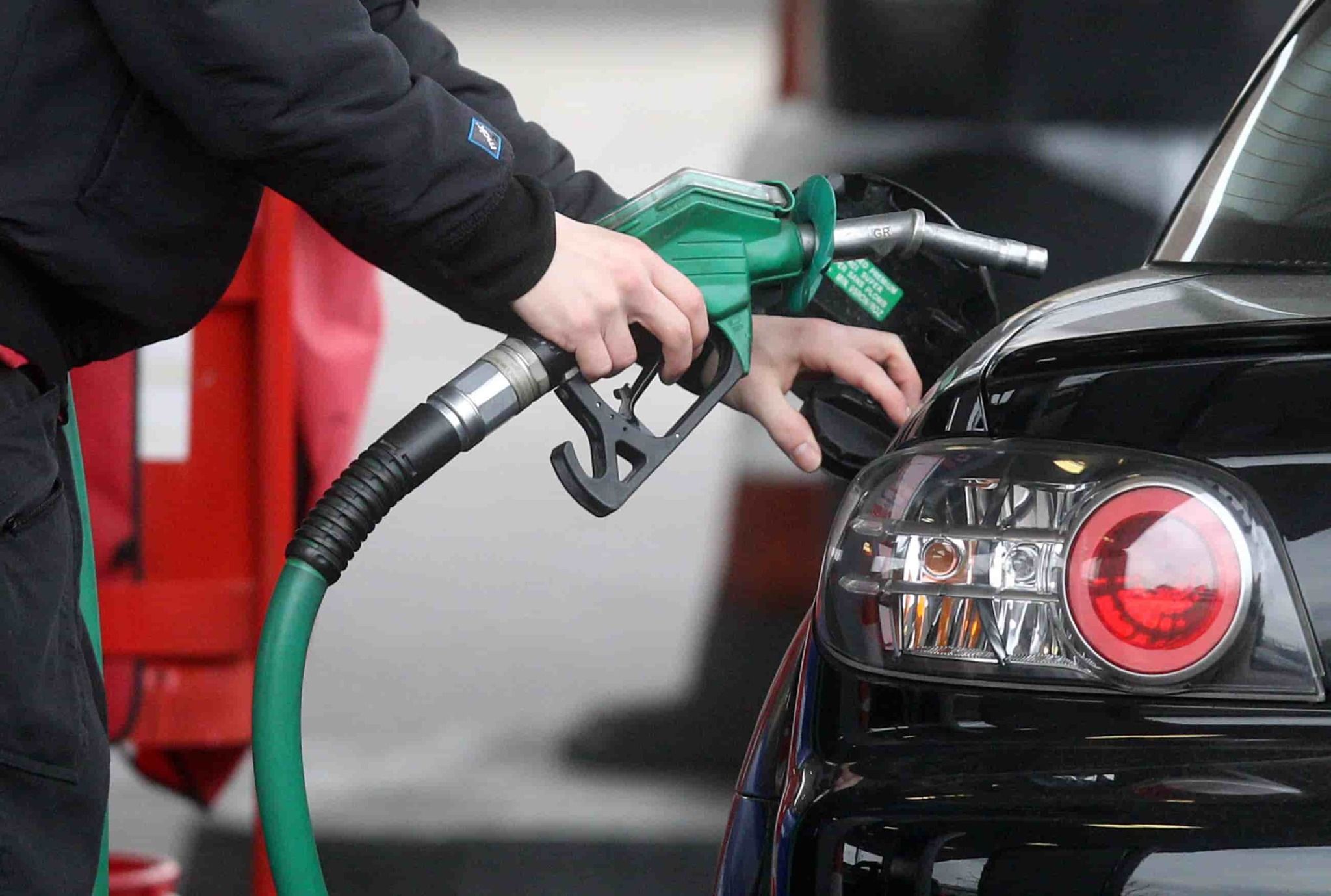 Image of Man Filing Up His Car at a Fuel Pump