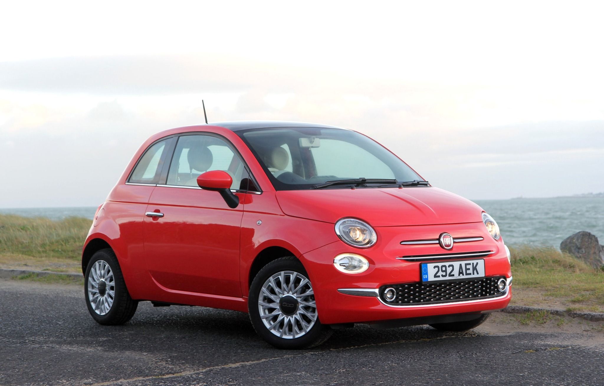 side view of red fiat 500