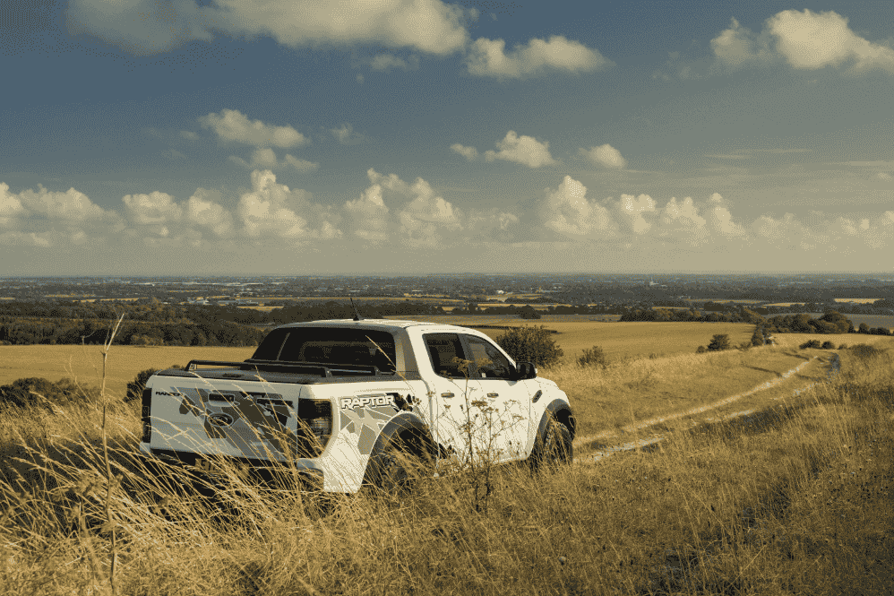 rear view of ford ranger raptor driving through countryside