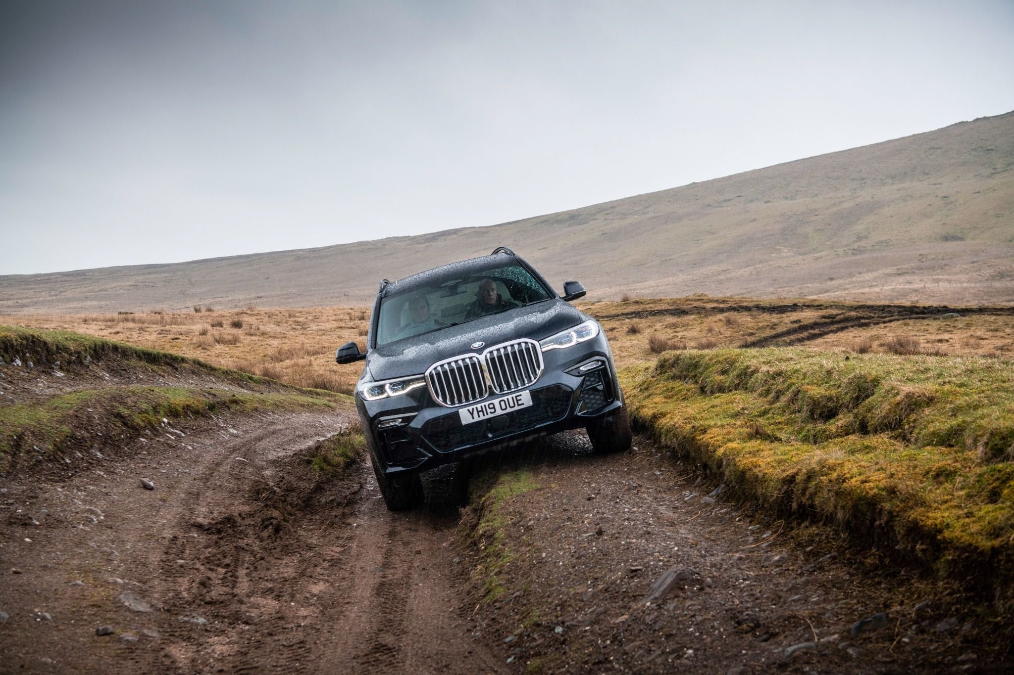front view of the BMW X7 driving on a road