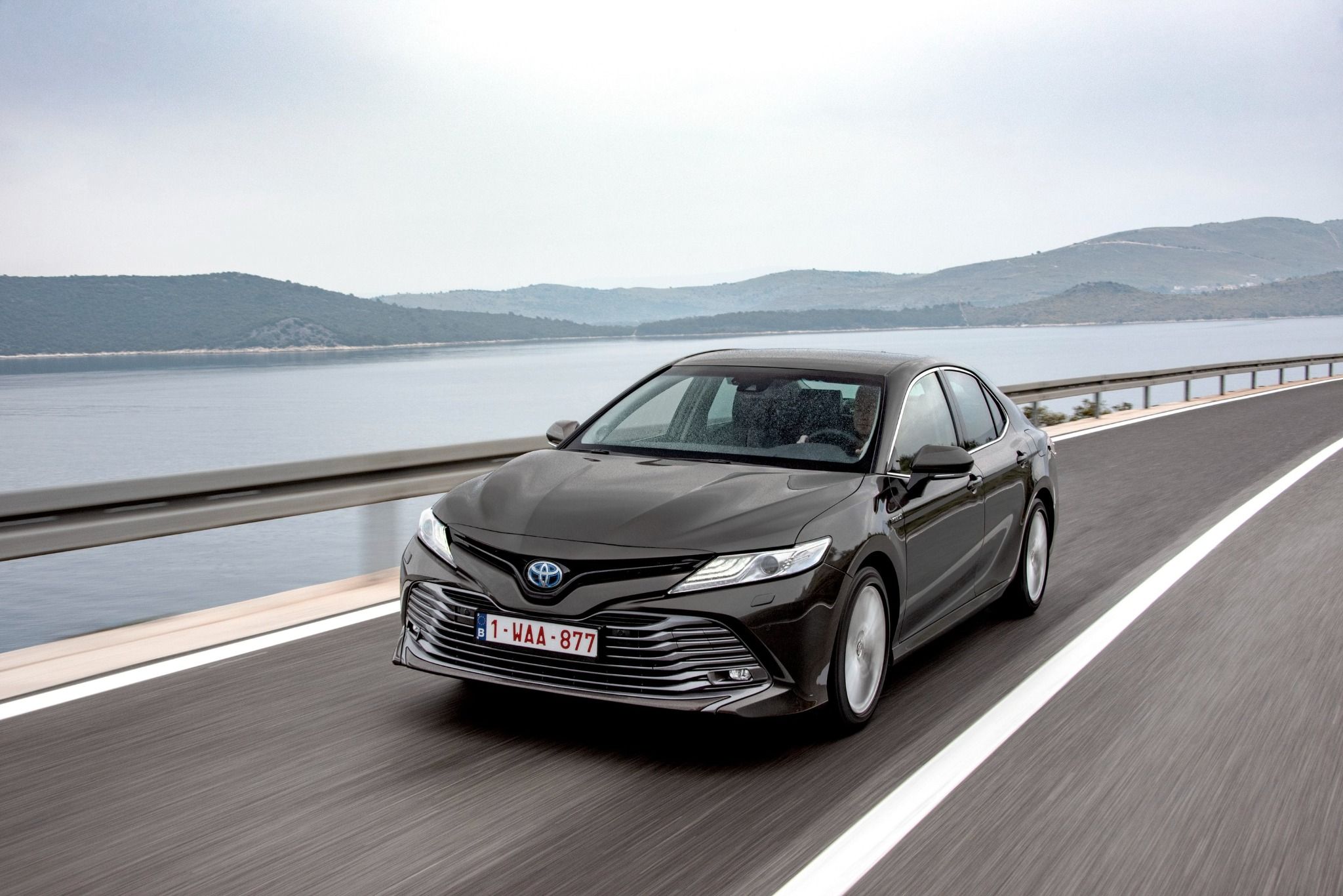 Toyota Camry driving on coastal road