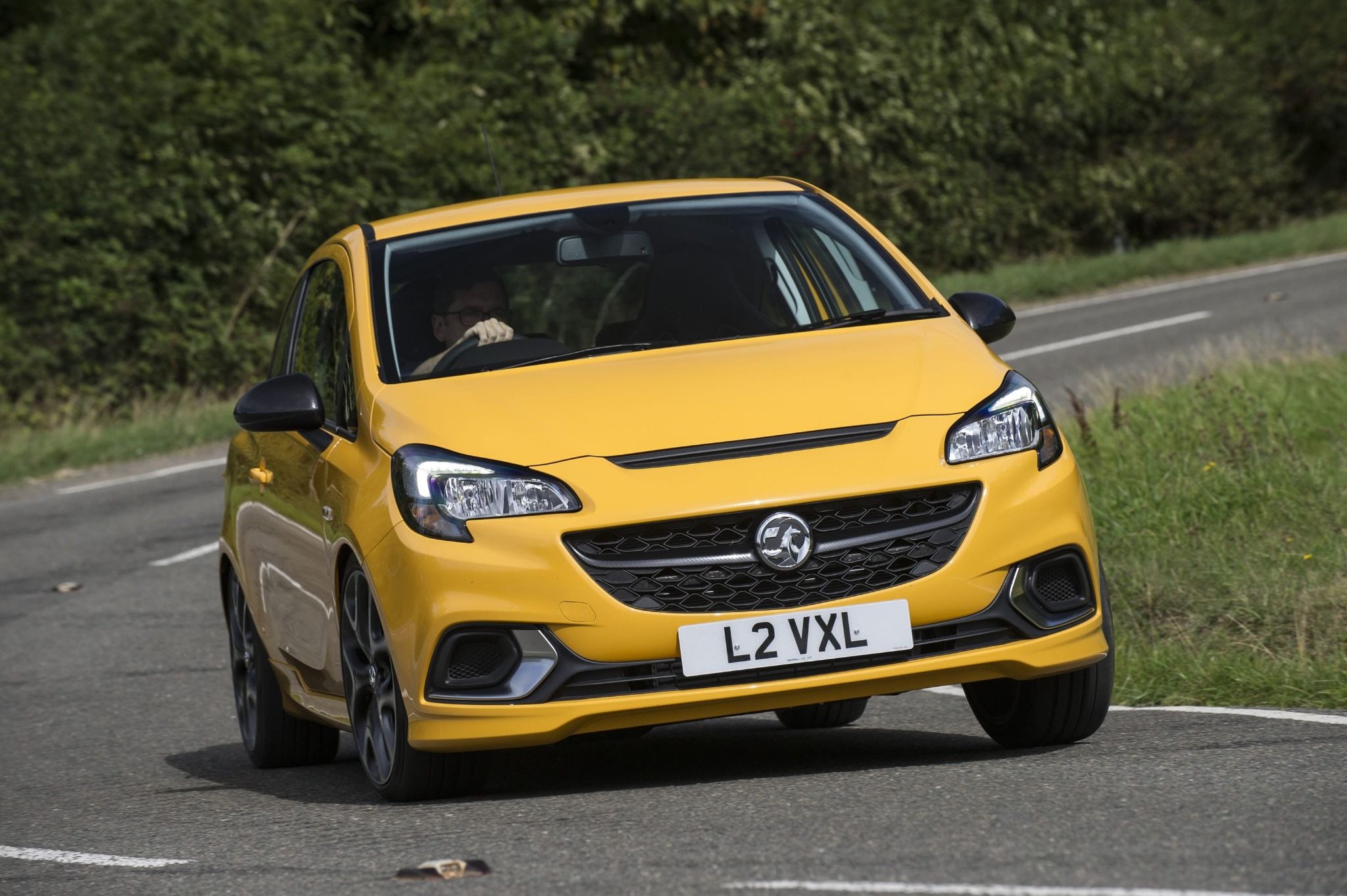 front view of vauxhall corsa driving down a bendy road
