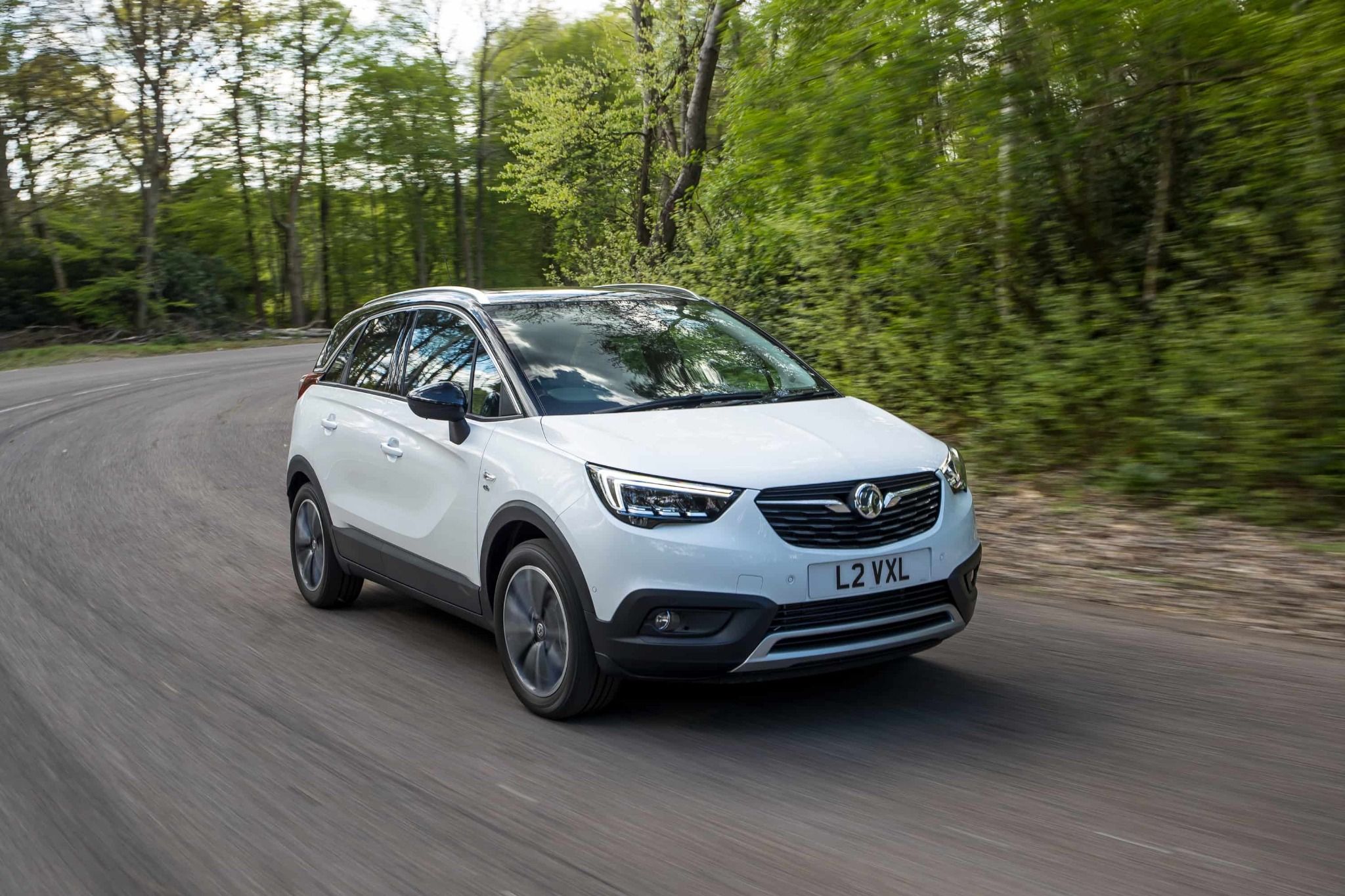 Crossland X driving on road White Crossland X Driving Through The Forest