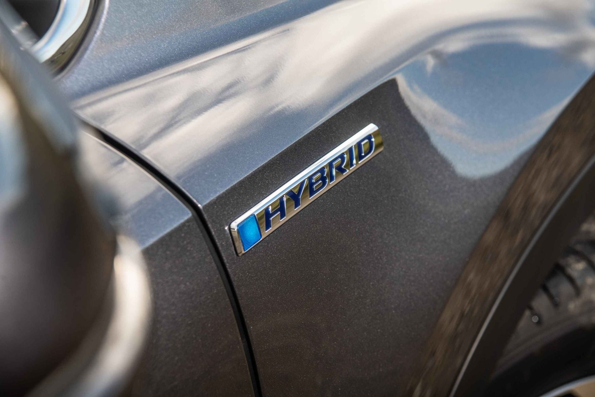 Close up of a hybrid badge on a car