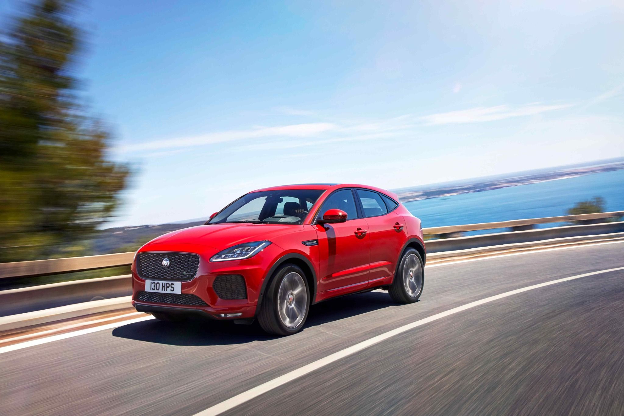 Red Jaguar E-Pace Driving Along the Coast Line