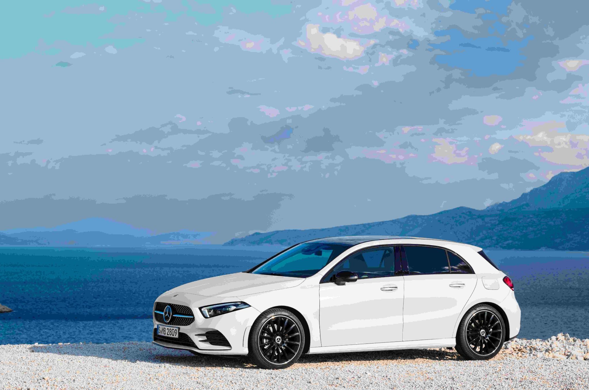 White Mercedes Benz A Class Parked In Front Of The Sea
