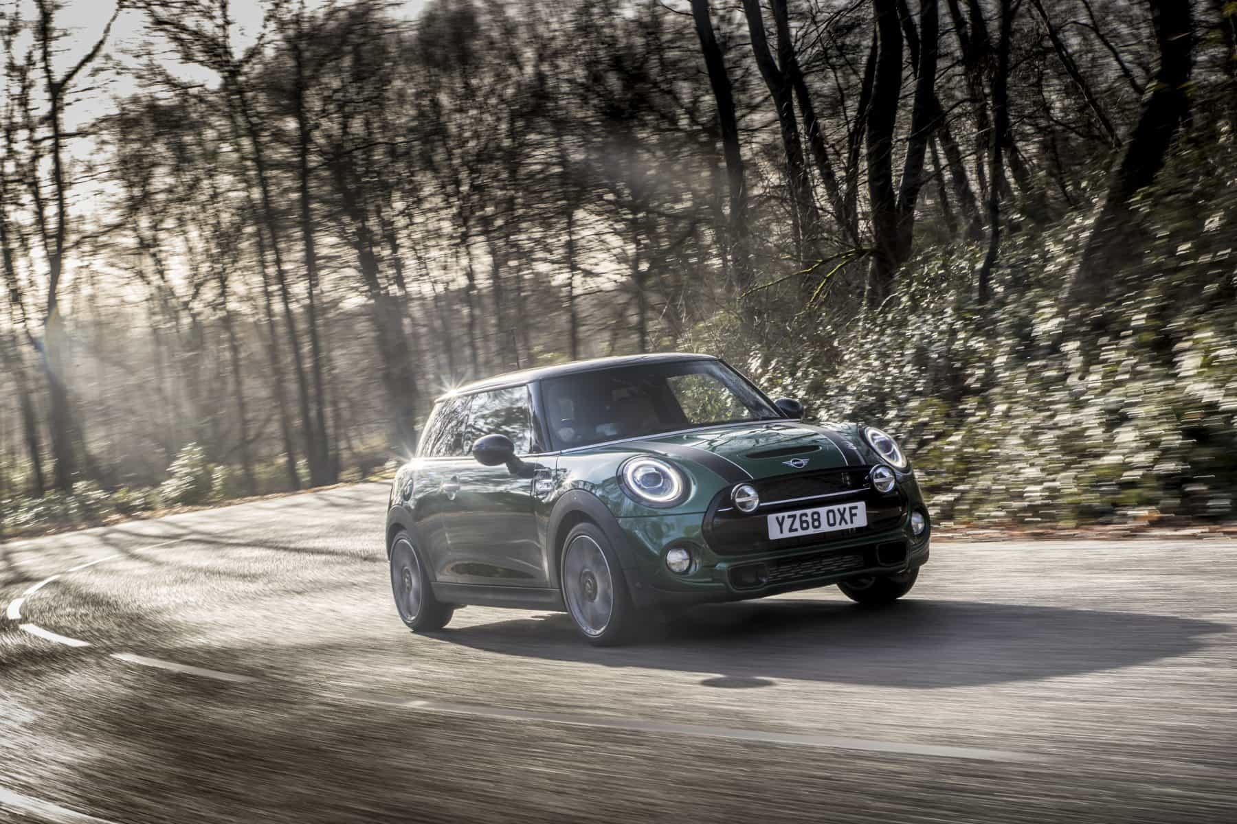Green Mini Driving Through the Woods