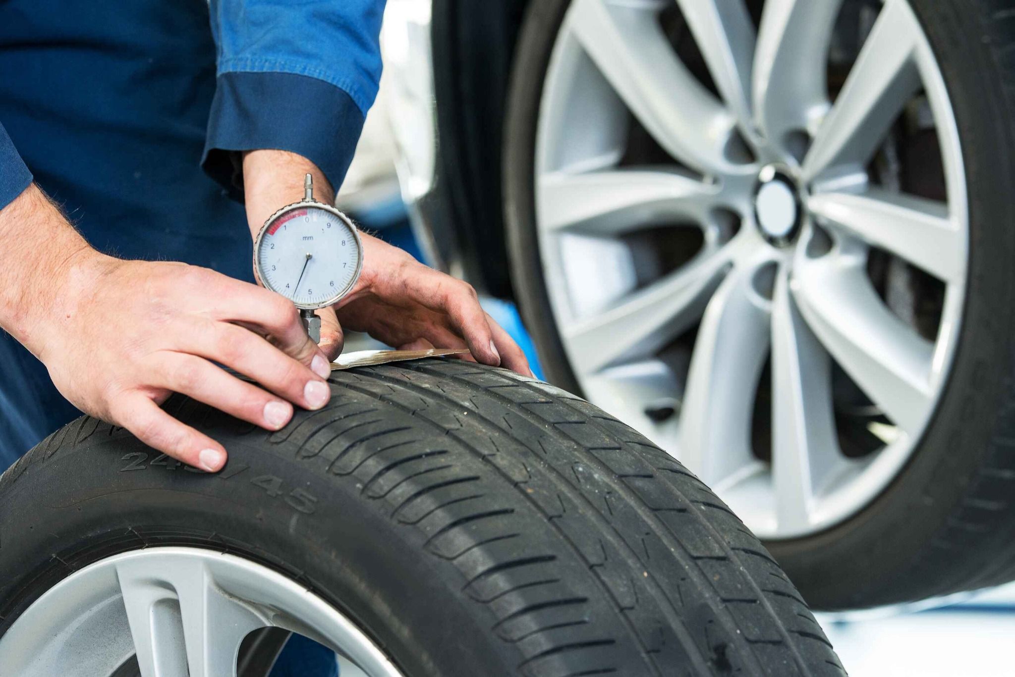 Man Checking Tyre in Workshop