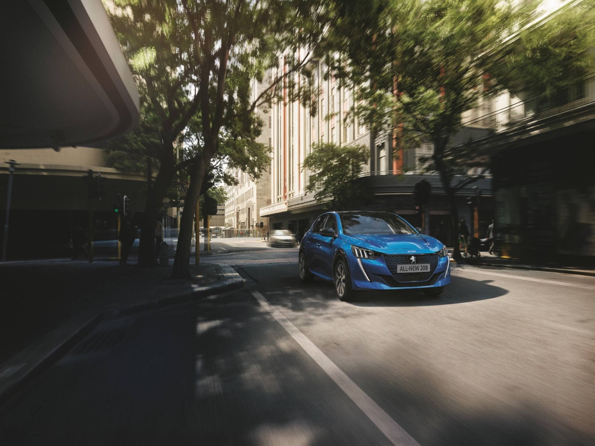 Blue Peugeot 208 Driving Along