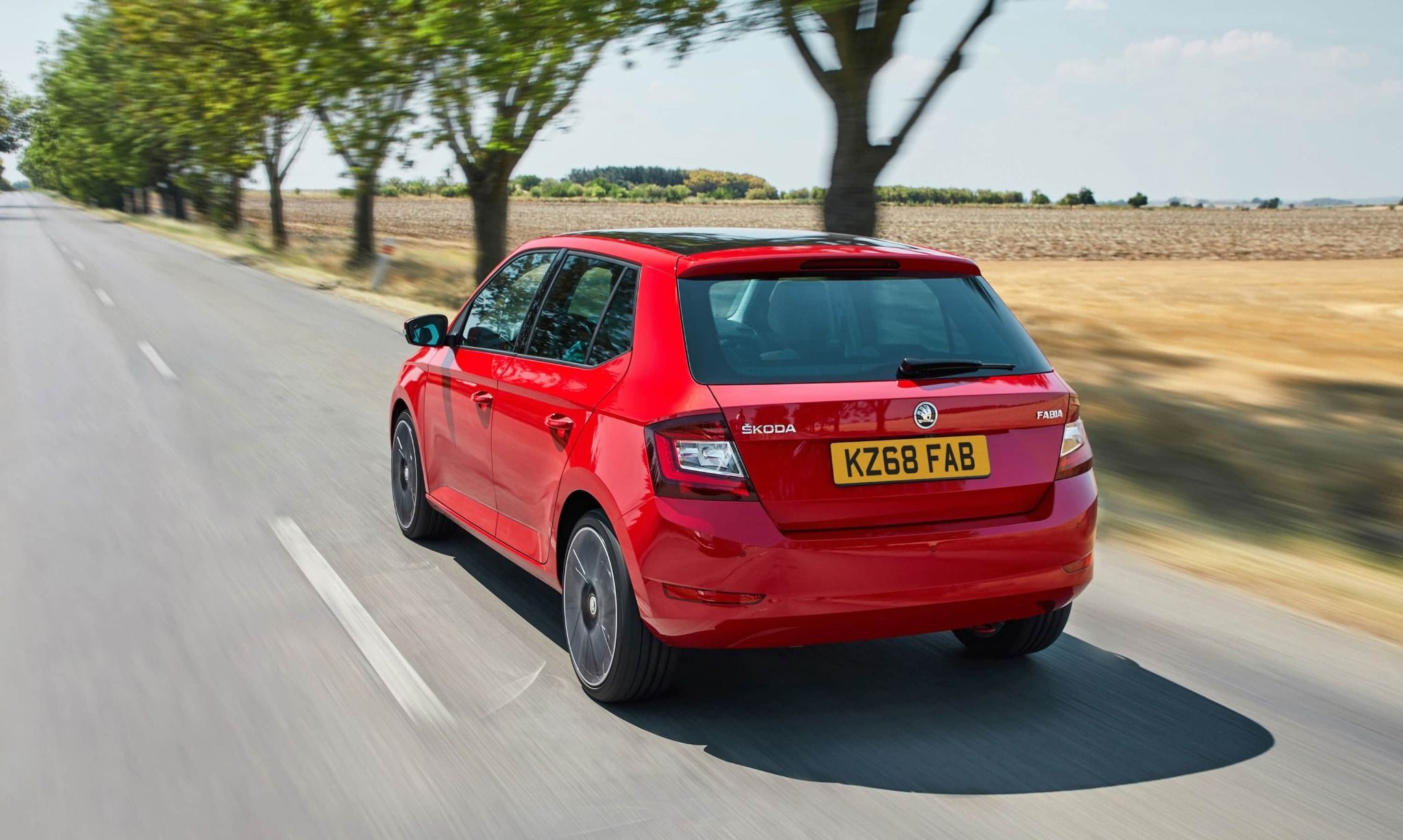 Red Skoda Driving Rear View