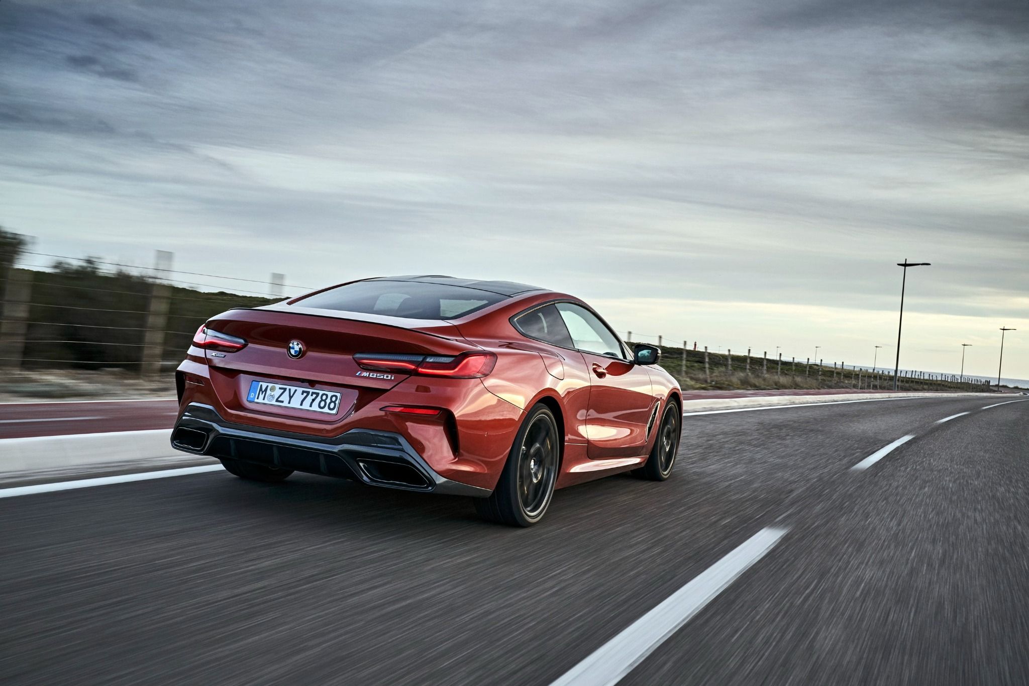 Rear of BMW 8 Series driving on road