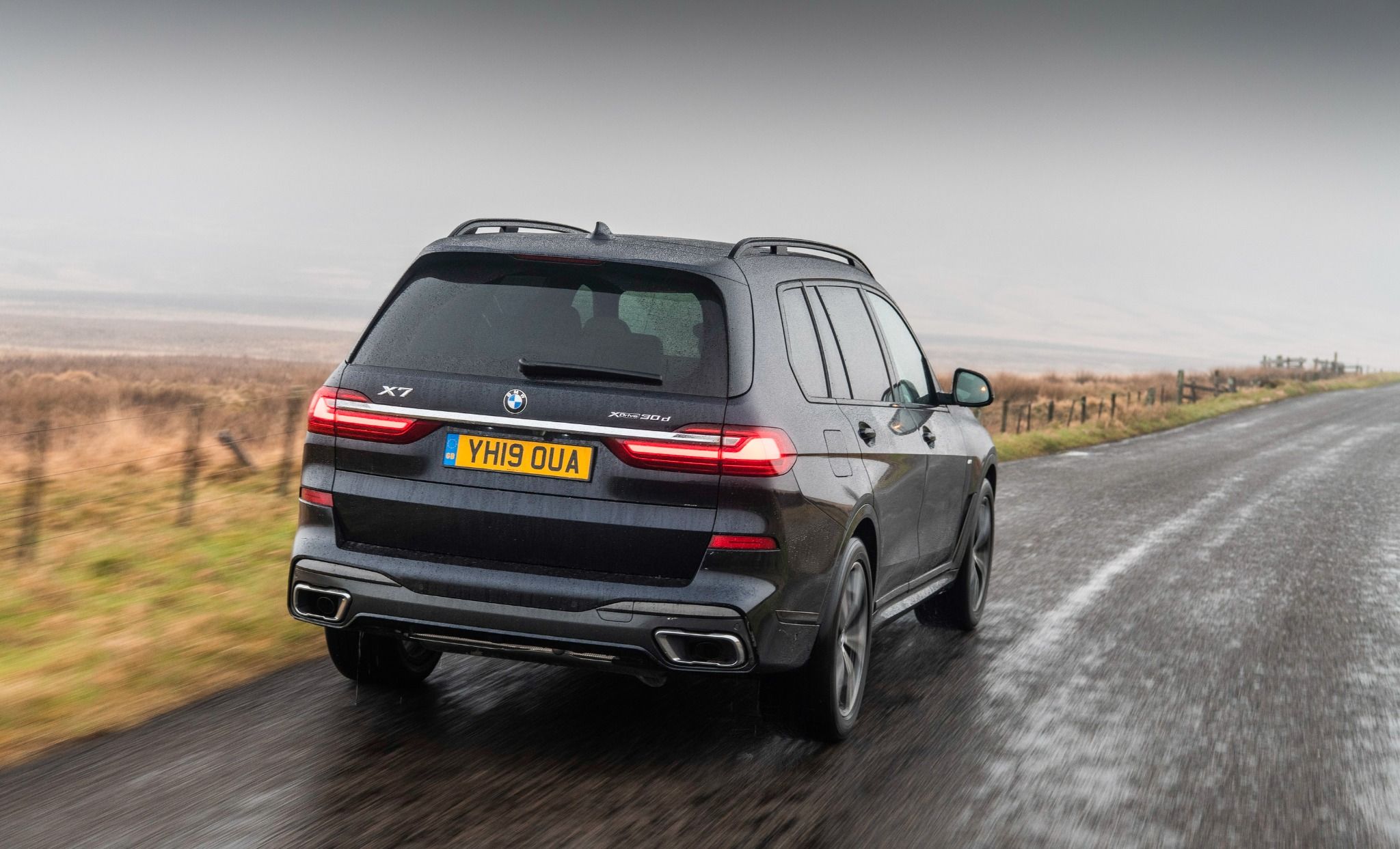 rear view of the BMW X7 driving on the road