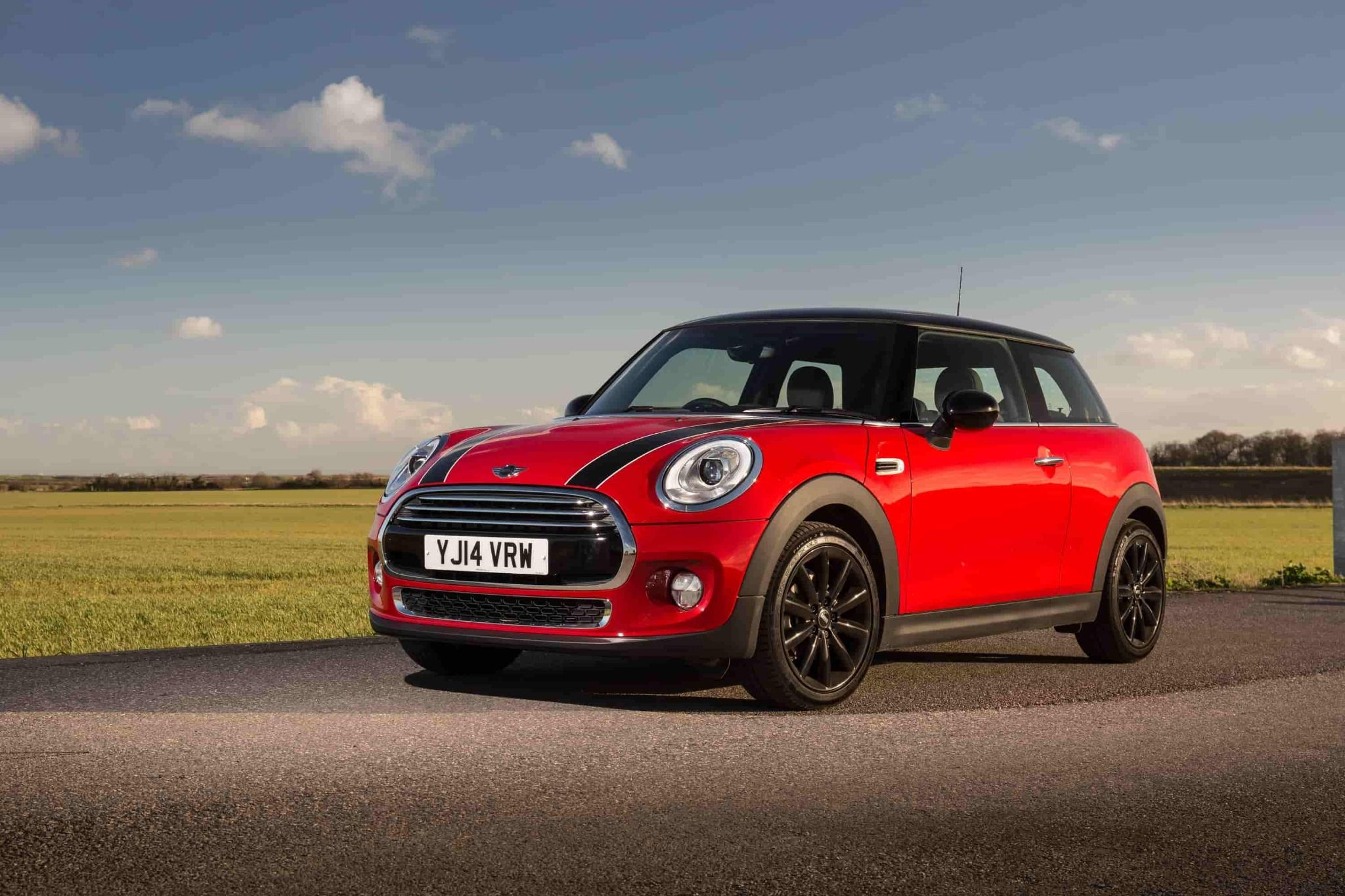Red Mini Cooper Driving Down Road