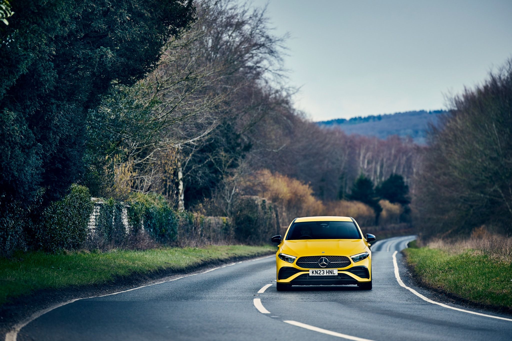 Yellow mercedes a-class driving