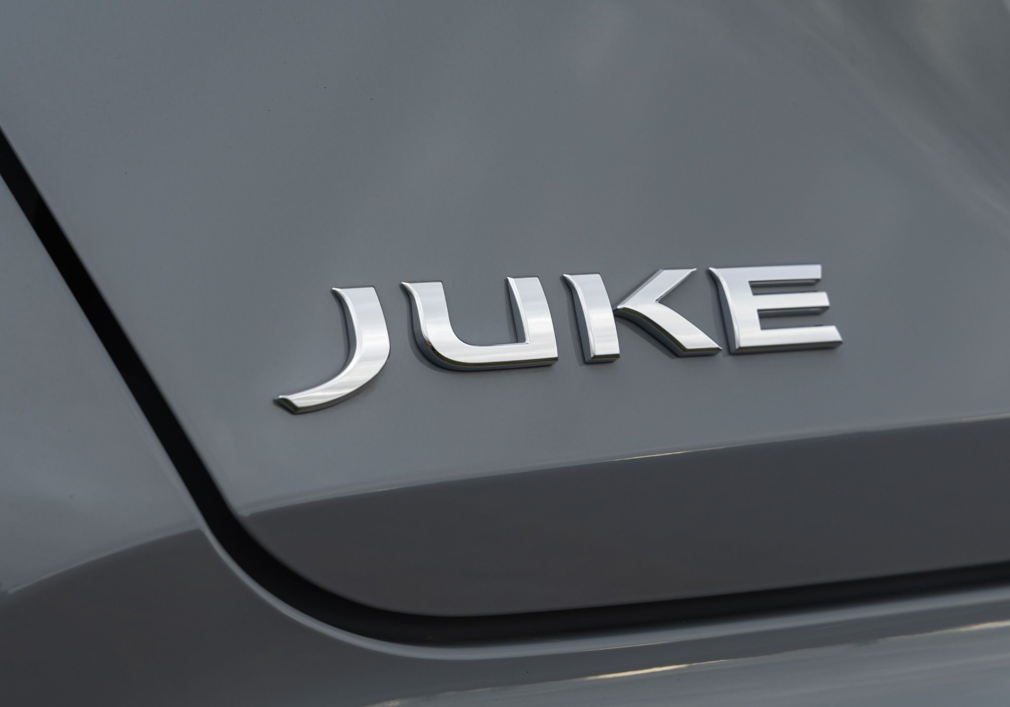 Grey Nissan Juke Hybrid badge