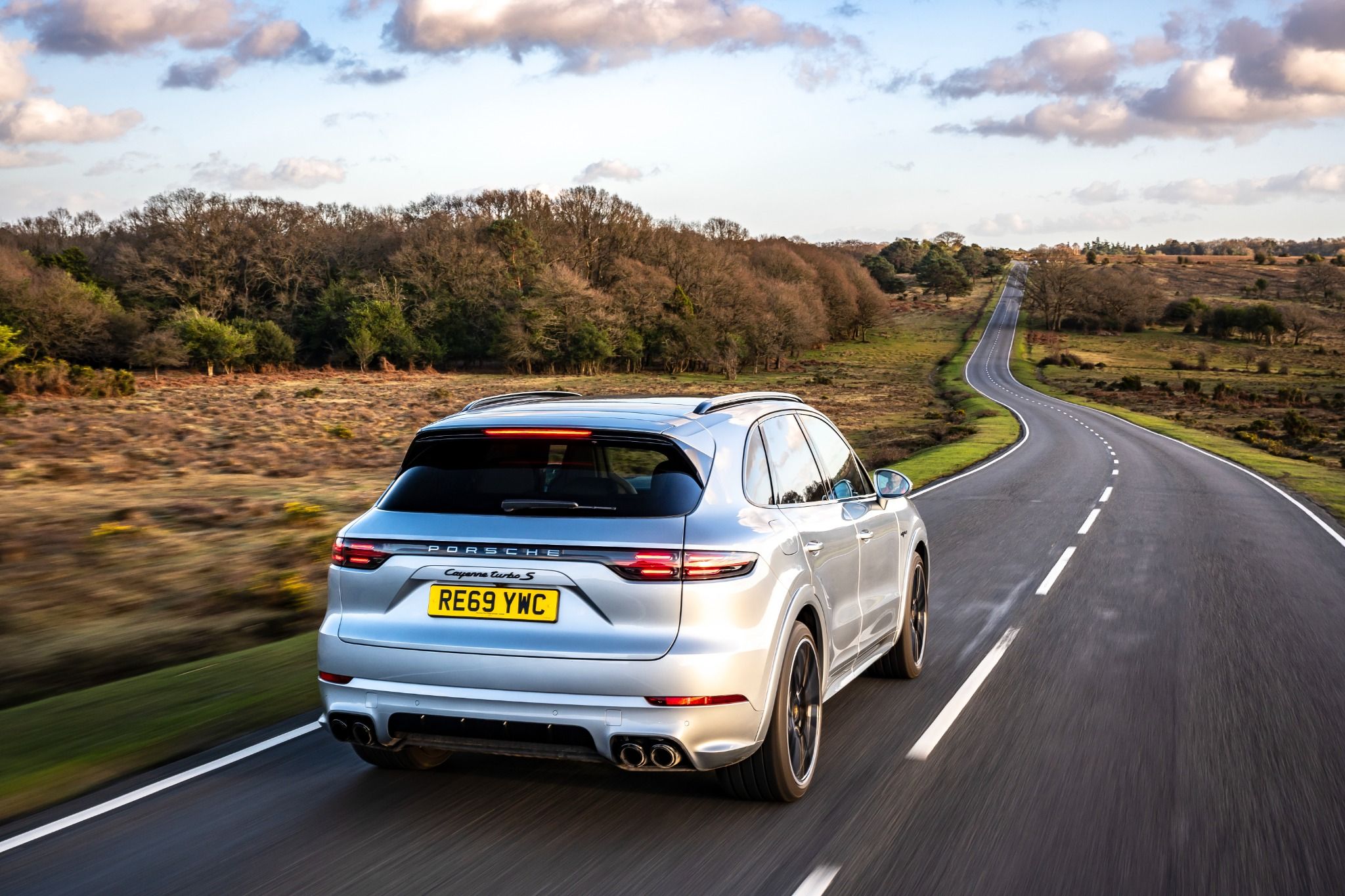 Rear view of a Porsche Cayenne driving on a road