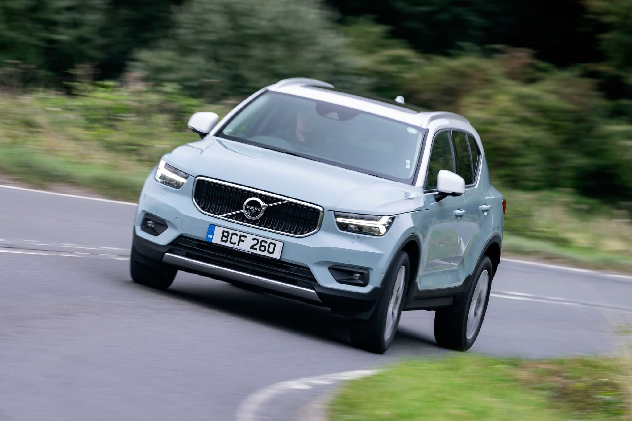 Silver Volvo Driving Down the road