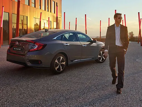 Man in suit walking away from New 2022 Honda Civic