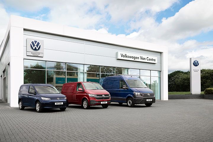 3 Volkswagen vans parked outside a commercial dealership