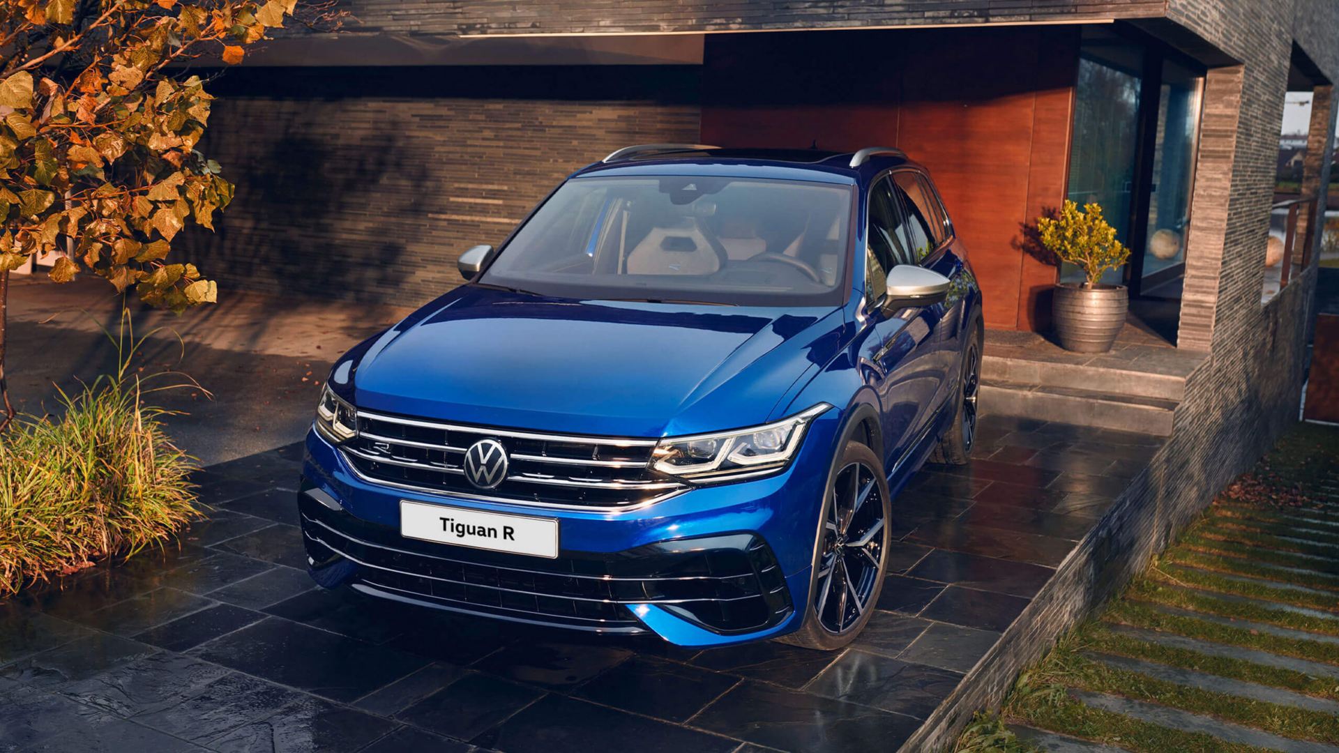 Blue Volkswagen Tiguan R front parked outside a house