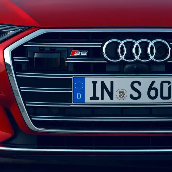 close up of a red audi s6 saloon front grille and badge