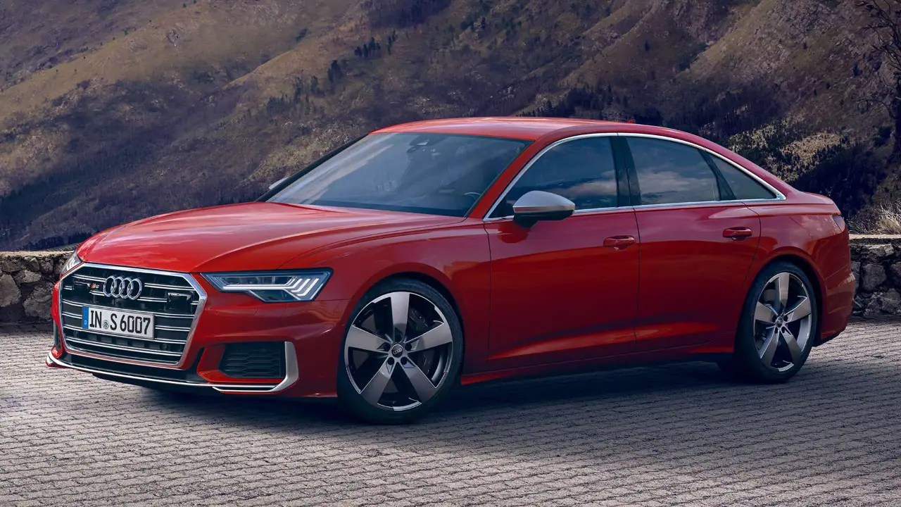 red audi s6 saloon front side exterior angles with car  parked in front of mountains
