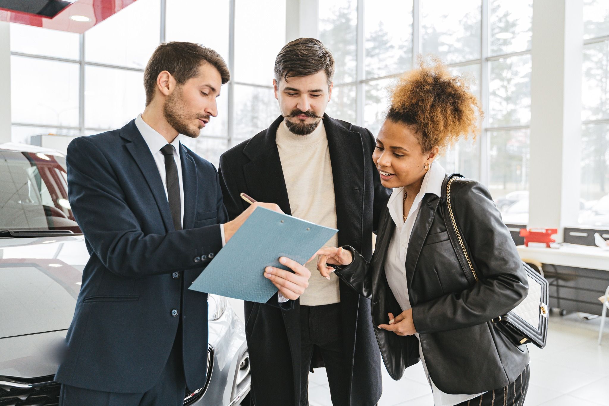 young couple in dealership with sales person