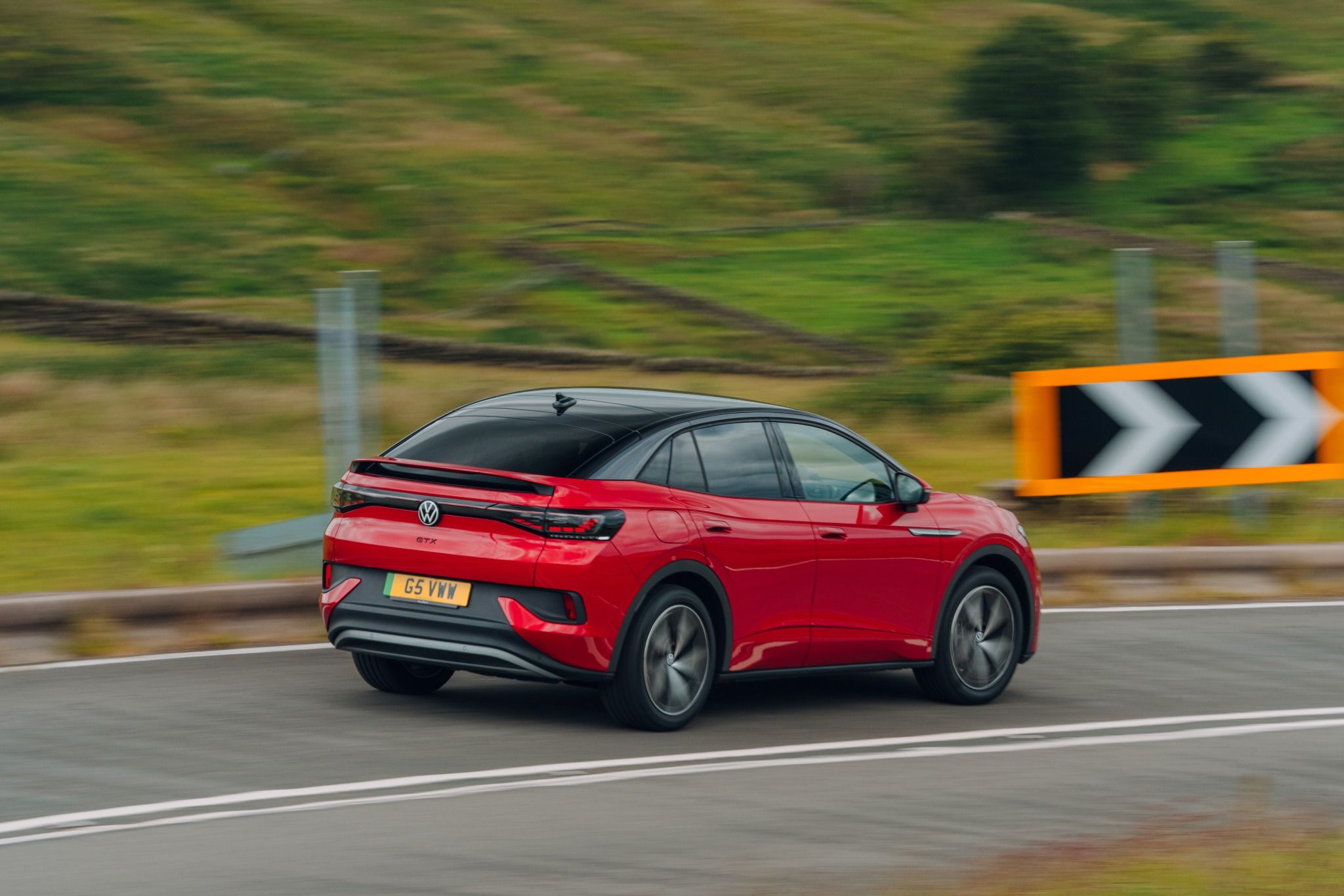 Volkswagen ID 4 in red driving on road