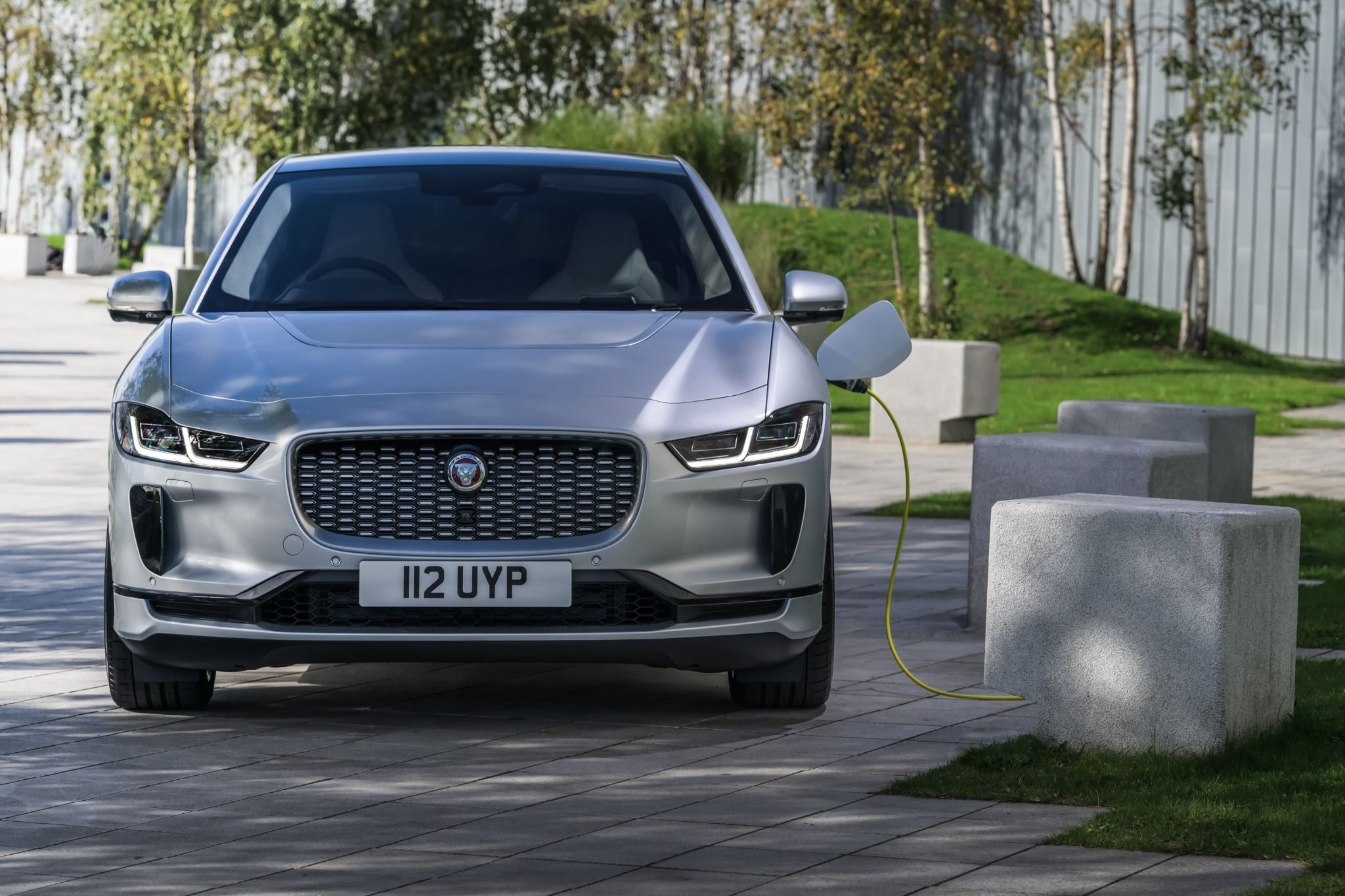 Front view of a silver Jaguar I-Pace charging