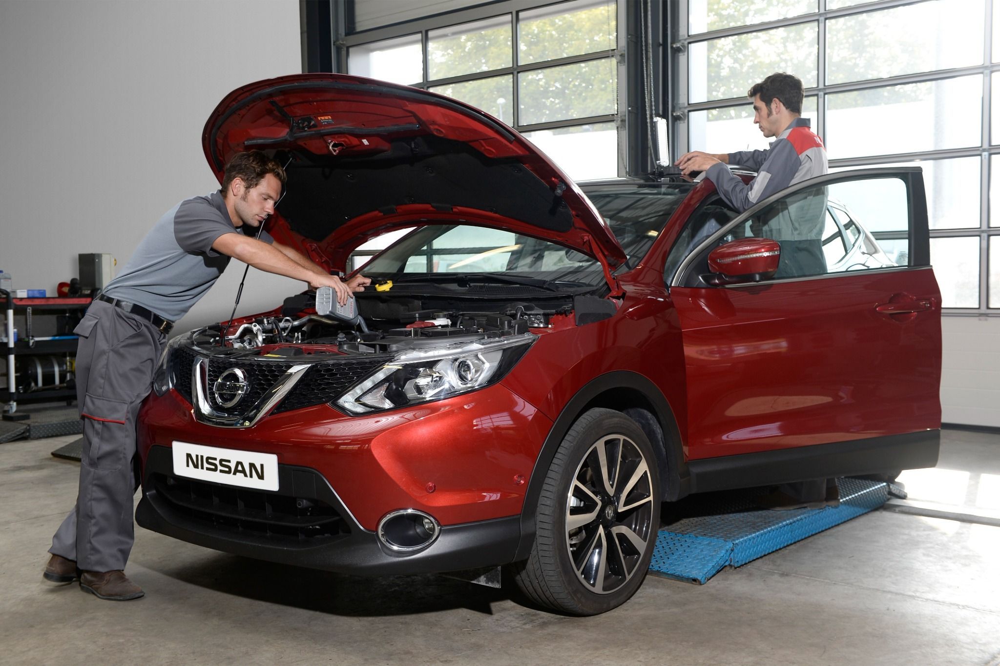 Technicians working on a Nissan