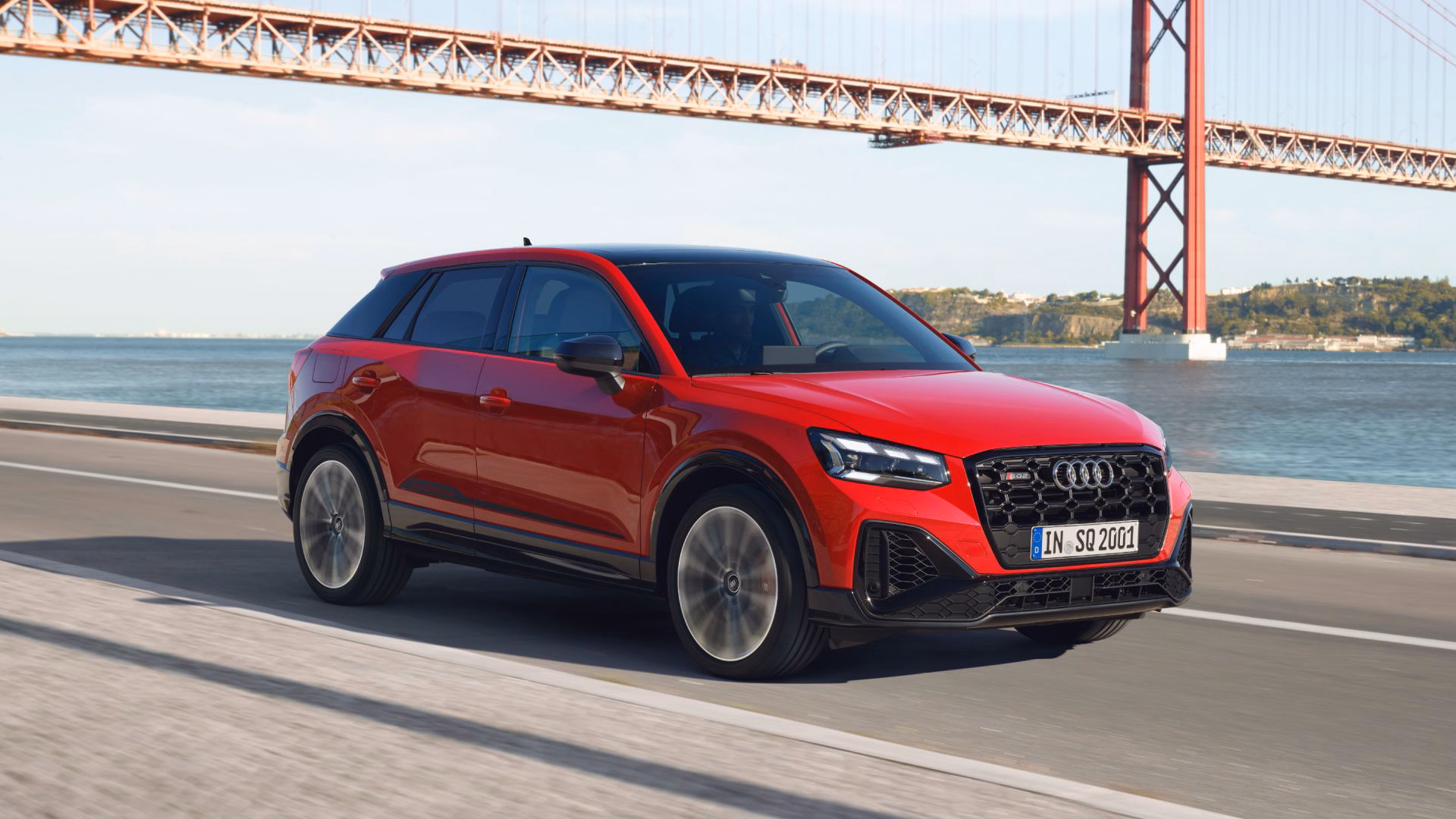 Red SQ2 driving on bridge