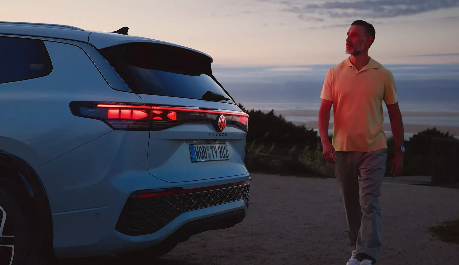 Man stood next to Volkswagen Tayron