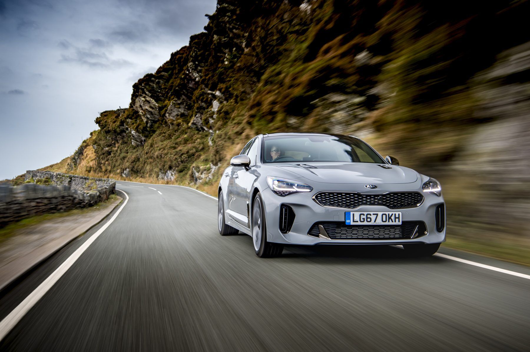Front view of a Kia Stinger driving down the road