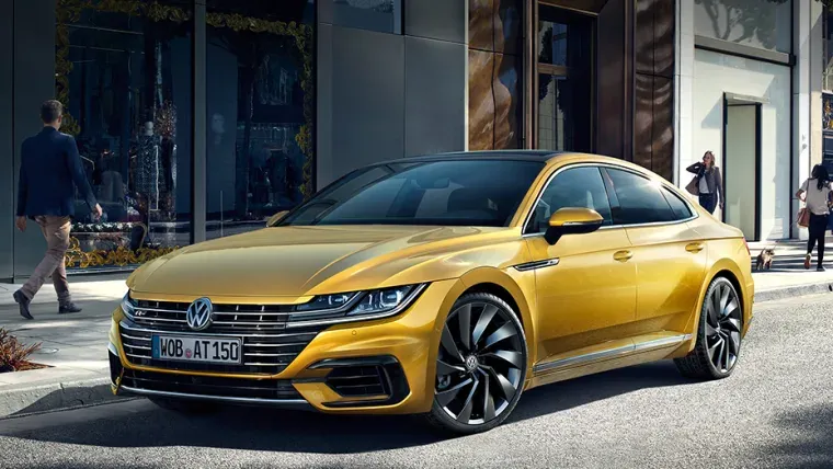 Yellow Volkswagen Arteon parked on a road