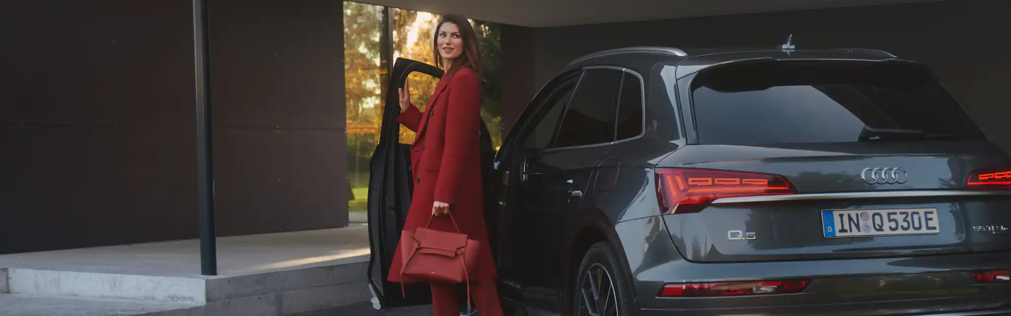 Businesswoman getting out of an Audi Q5